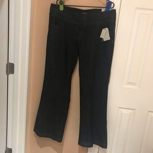 Wide legged, dark wash trouser jeans with tags.